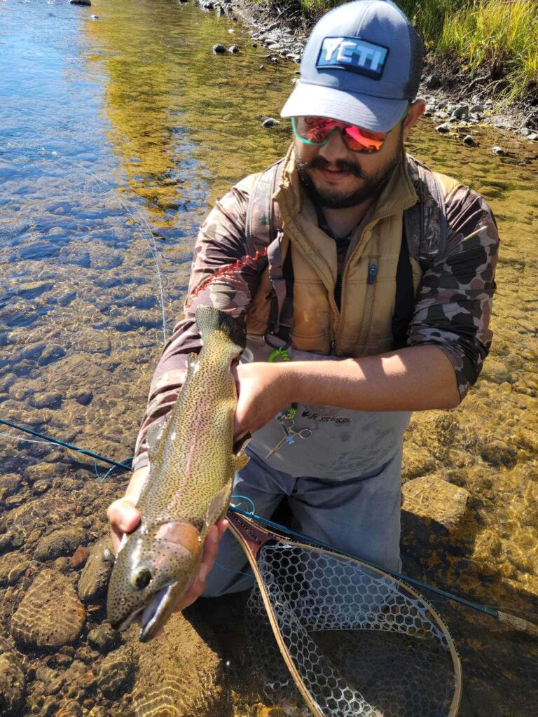 Picture of James with a rainbow trout on his arm